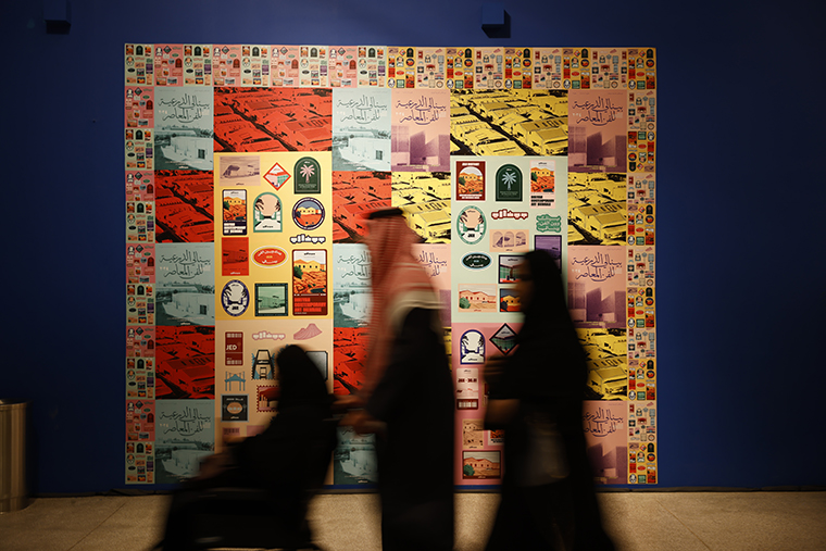 Visitors in front of a colorful artwork at Diriyah Contemporary Art Biennale 2026, JAX District